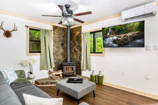 338 Canter Ct, Ellijay, GA 30540 - living room with a wall mounted air conditioner, a wood stove, a ceiling fan, wood finished floors, and baseboards