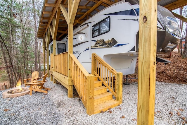 wooden deck featuring an outdoor fire pit