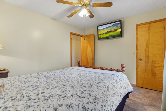 bedroom with a textured ceiling, a ceiling fan, and carpet floors