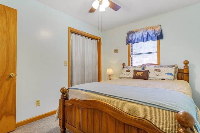 carpeted bedroom with a ceiling fan and baseboards