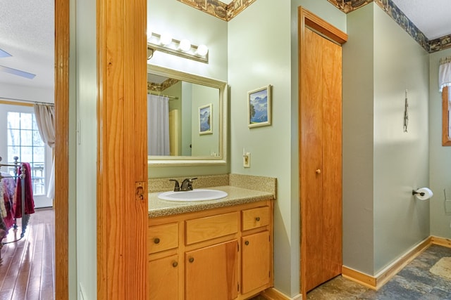 bathroom with vanity and baseboards