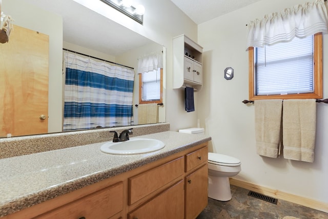 full bathroom with visible vents, baseboards, toilet, a shower with shower curtain, and vanity