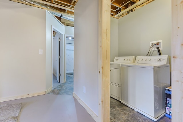 laundry room with baseboards, washing machine and dryer, and laundry area