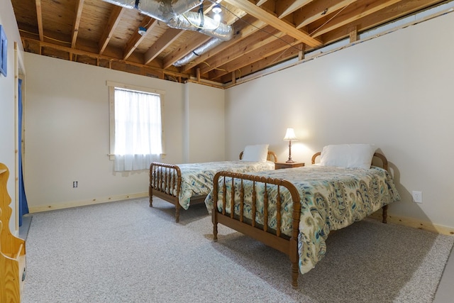 carpeted bedroom featuring baseboards