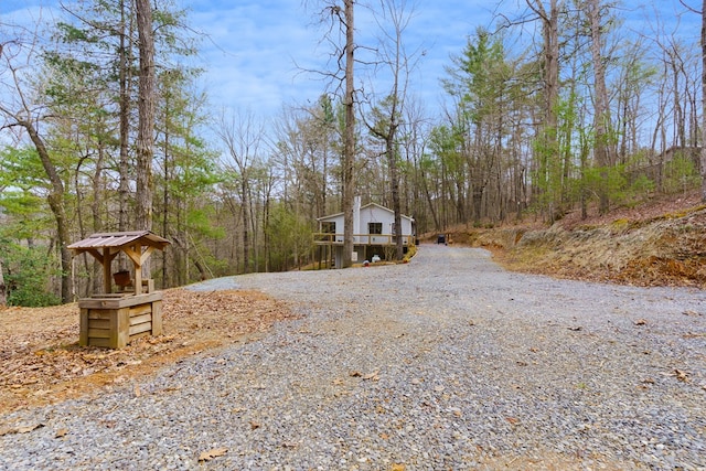 exterior space with a wooded view and driveway