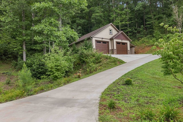 view of front facade featuring a garage and an outbuilding