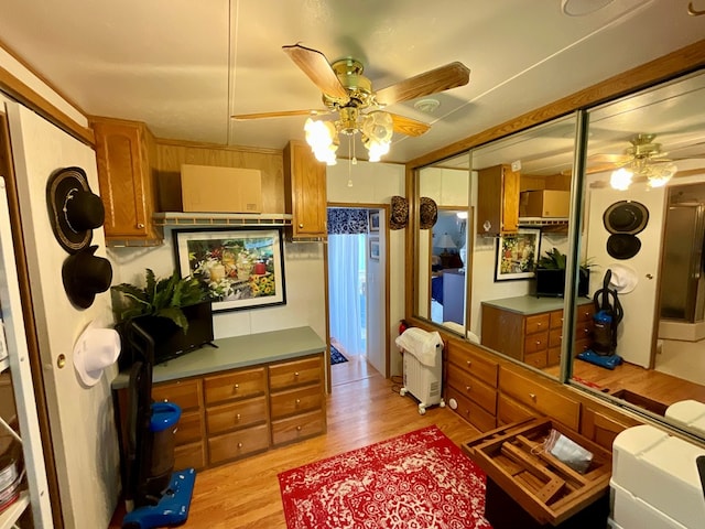 bedroom featuring built in desk, light hardwood / wood-style flooring, and a closet