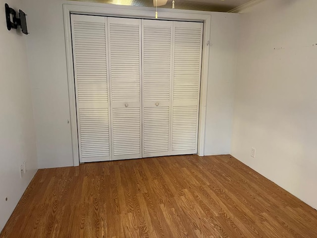 unfurnished bedroom featuring a closet and light wood-type flooring