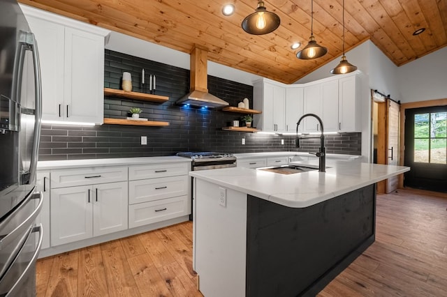 kitchen featuring a barn door, white cabinetry, and wooden ceiling