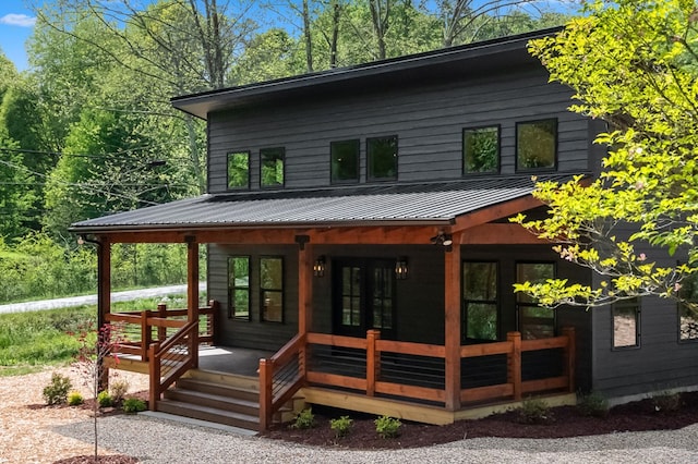 rear view of house featuring a porch