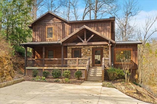 view of front of home featuring a porch, board and batten siding, and metal roof