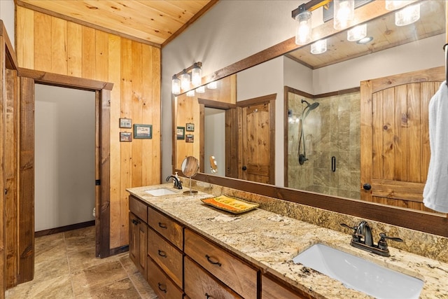 bathroom featuring wood walls, wooden ceiling, a stall shower, and a sink