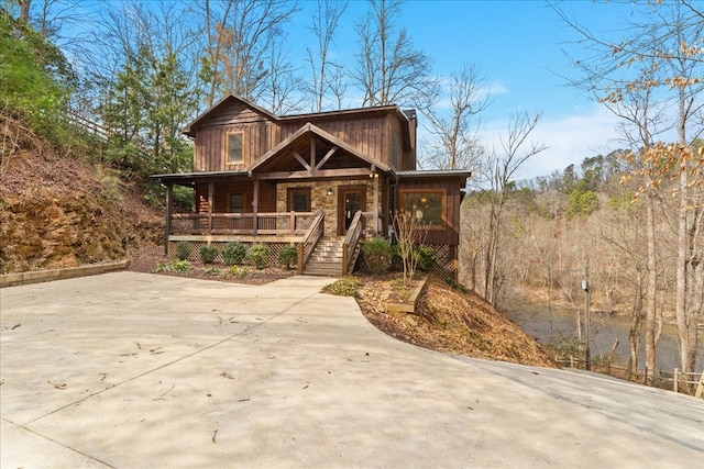 view of front of house with covered porch and stone siding