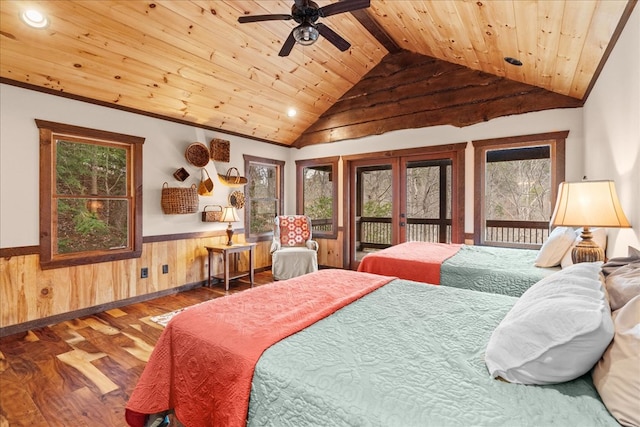 bedroom featuring wood finished floors, access to exterior, vaulted ceiling, wood ceiling, and wainscoting