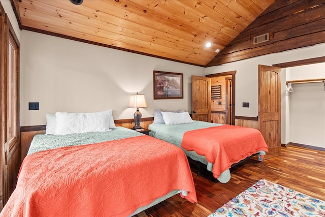 bedroom with visible vents, lofted ceiling, wood finished floors, baseboards, and wood ceiling