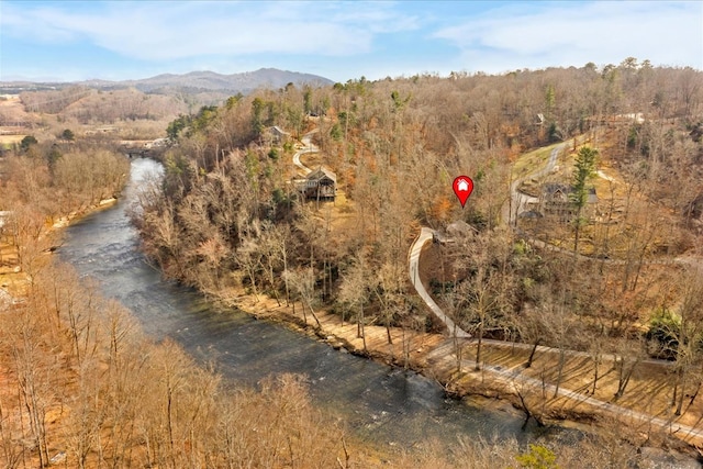 drone / aerial view featuring a view of trees and a mountain view