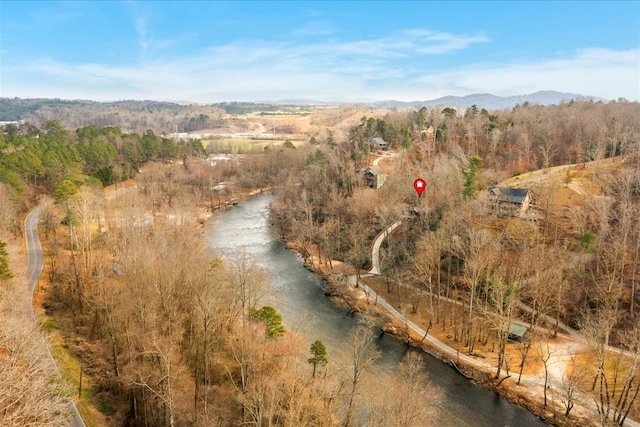 birds eye view of property with a mountain view and a wooded view