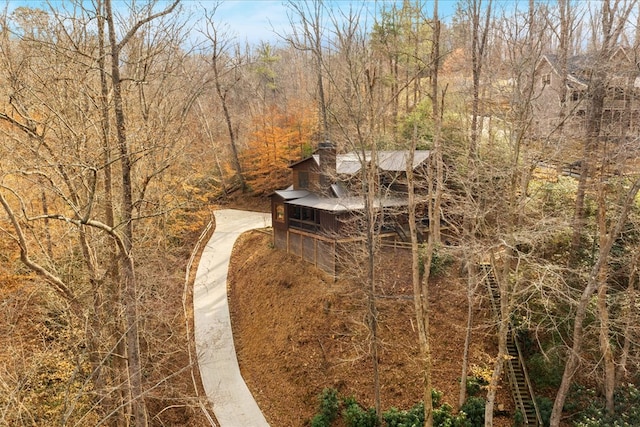 drone / aerial view featuring a wooded view