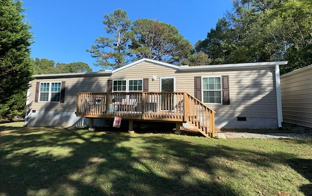 rear view of property featuring a lawn and a deck