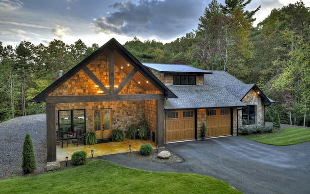 view of front of home featuring a garage and a yard