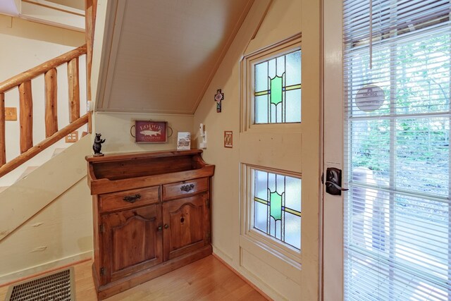 entryway featuring vaulted ceiling and light hardwood / wood-style floors