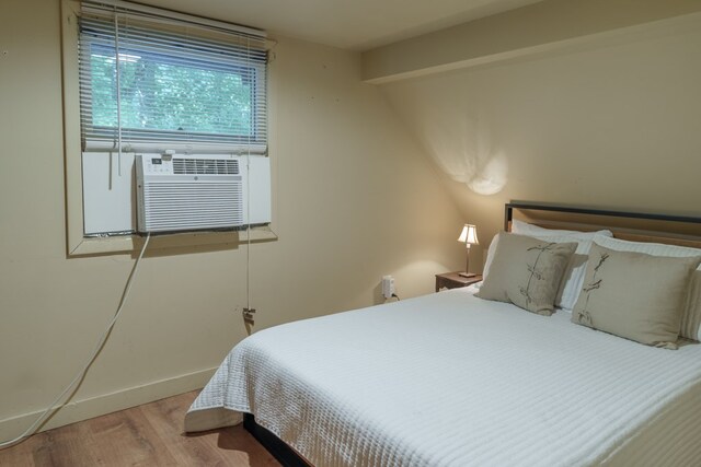 bedroom with hardwood / wood-style floors