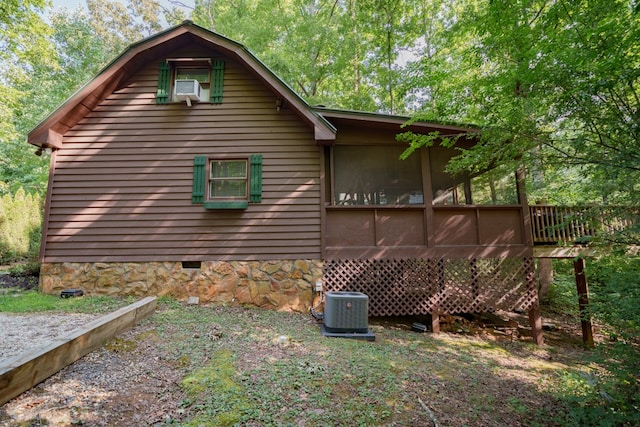 view of home's exterior featuring central air condition unit and a wooden deck