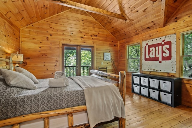 bedroom with wooden walls, access to outside, vaulted ceiling with beams, wood ceiling, and hardwood / wood-style flooring