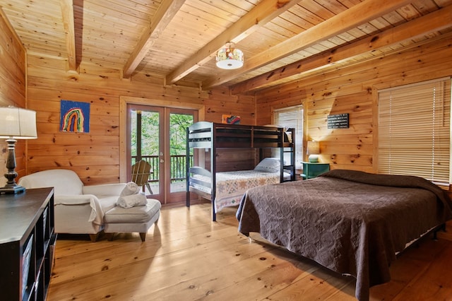 bedroom with access to exterior, hardwood / wood-style flooring, beam ceiling, and french doors