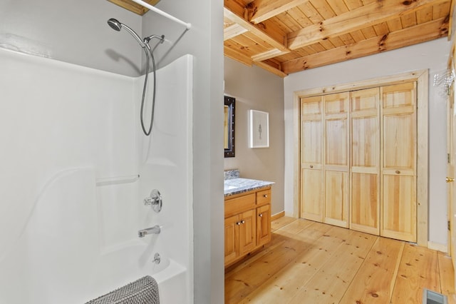 bathroom with vanity, beamed ceiling, wood-type flooring, wood ceiling, and washtub / shower combination