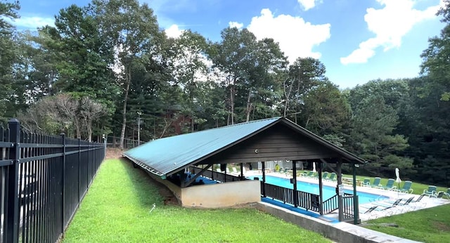 view of home's community with a swimming pool and a lawn