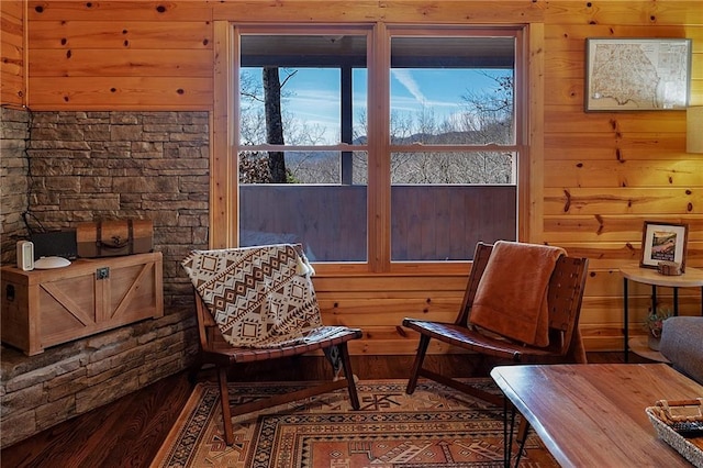 living area featuring wood walls