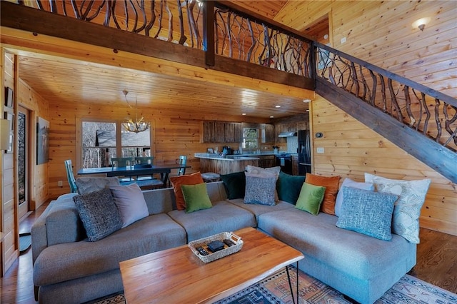 living room featuring wood ceiling and wood walls