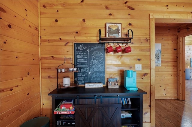 interior space with hardwood / wood-style floors and wood walls