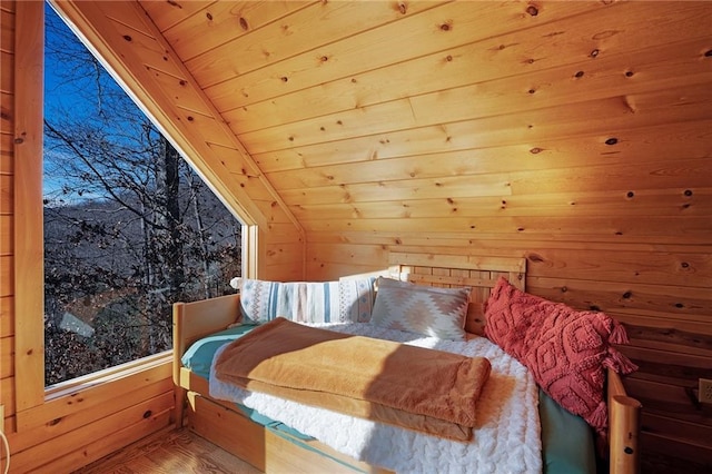 bedroom featuring lofted ceiling, wood ceiling, hardwood / wood-style flooring, and wood walls