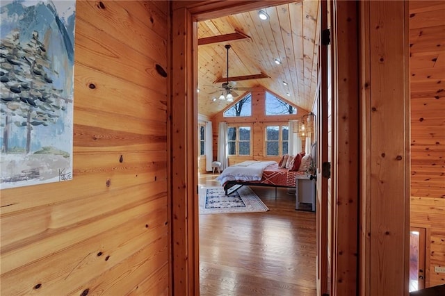 hall with wood ceiling, lofted ceiling, hardwood / wood-style floors, and wood walls