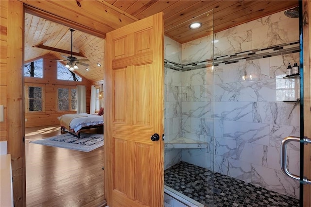 bathroom with wood-type flooring, lofted ceiling, walk in shower, ceiling fan, and wood ceiling