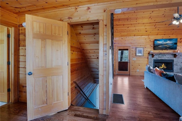 interior space featuring hardwood / wood-style floors, wood ceiling, and wood walls