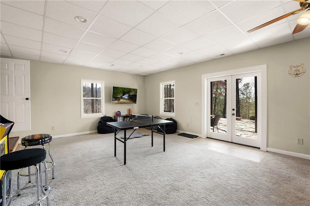 game room featuring light carpet, plenty of natural light, french doors, and a paneled ceiling