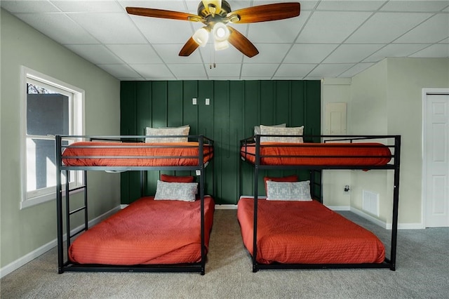 carpeted bedroom with a paneled ceiling