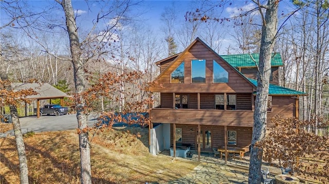 view of front of home featuring a patio area and a carport