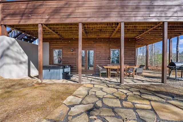 view of patio / terrace featuring a hot tub and french doors