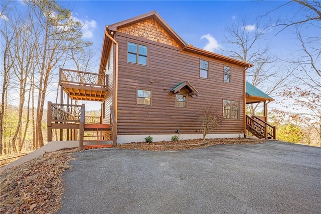 view of side of property featuring a wooden deck