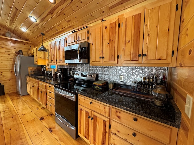 kitchen featuring sink, wood ceiling, dark stone countertops, pendant lighting, and stainless steel appliances