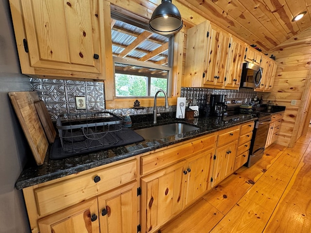 kitchen featuring sink, wood ceiling, dark stone countertops, stainless steel appliances, and vaulted ceiling