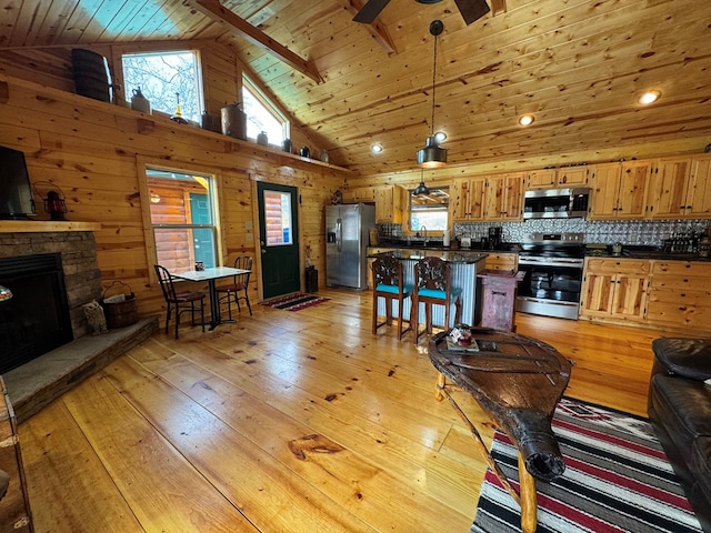 living room with a stone fireplace, wooden ceiling, ceiling fan, and light hardwood / wood-style flooring