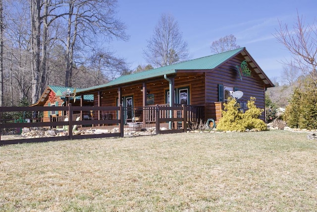 log cabin featuring a porch and a front lawn