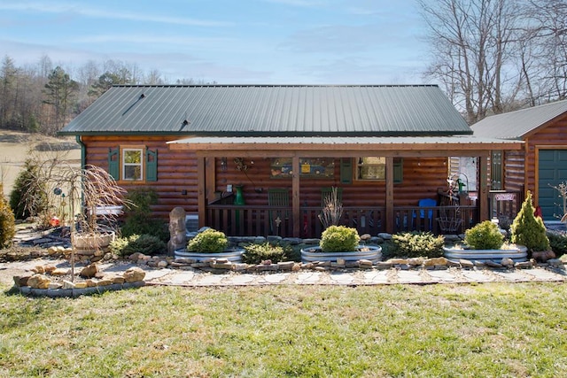 rear view of property featuring a lawn