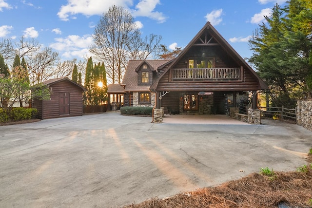 686 Lake Dr N, Morganton, GA 30560 - log home with concrete driveway, a porch, a balcony, and stone siding