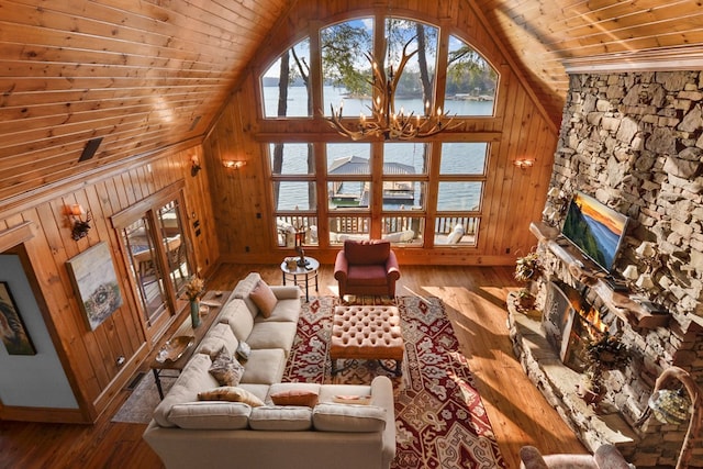 686 Lake Dr N, Morganton, GA 30560 - living area with lofted ceiling, hardwood / wood-style floors, wooden ceiling, healthy amount of natural light, and a stone fireplace